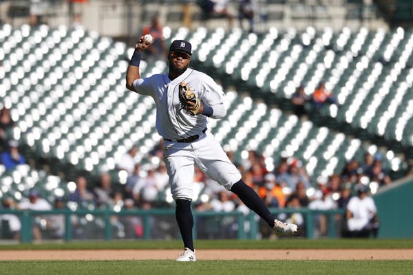 Detroit Tigers third baseman Dawel Lugo throws to first base against the Minnesota Twins in the seventh inning of a baseball game in Detroit, Thursday
