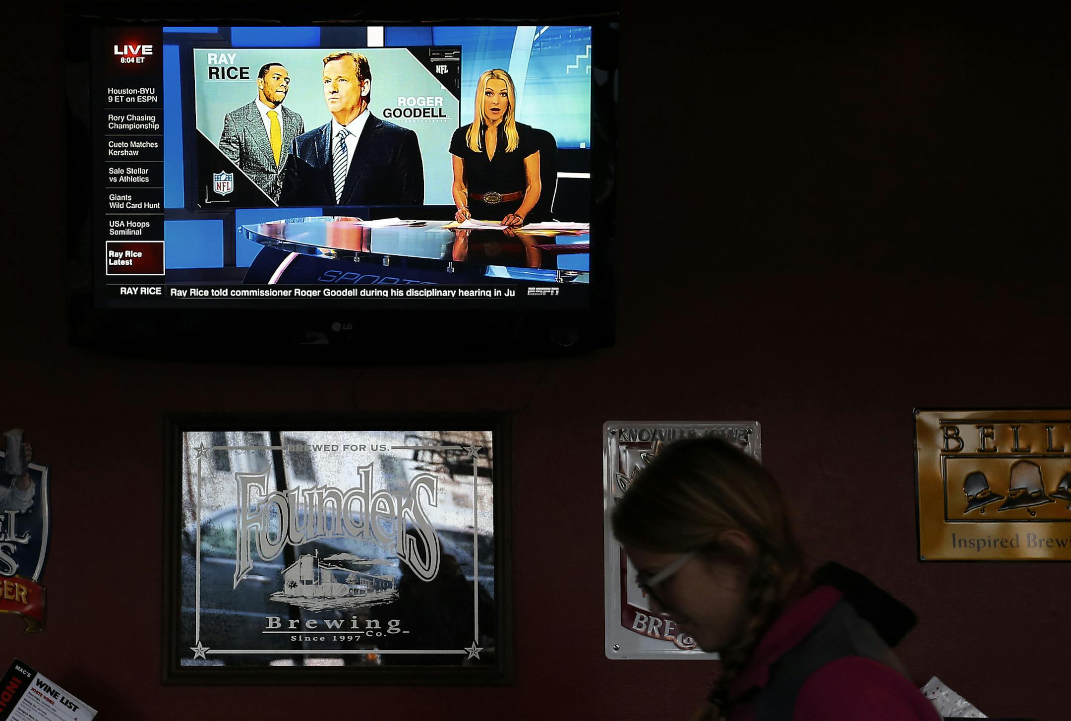 Football fans Christina Landrum, 25, and Ashley Peterson, 25 both of Minneapolis watched the Pittsburg Steelers vs. Baltimore Ravens game at the Mac's Industrial sports bar on Thursday night. ] CARLOS GONZALEZ cgonzalez@startribune.com - September 11, 2014, Minneapolis, Minn., Macs Industrial sports bar, a Ravens bar, female fans watching football at some local bars. How do they feel about the Ray Rice situation?