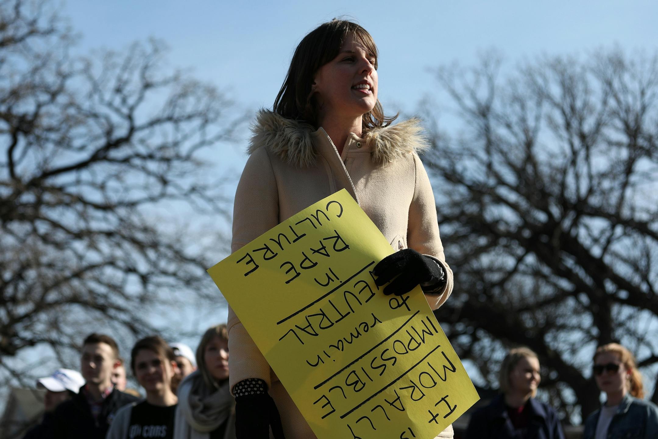 Organizer Sarah Super talks to the group of students, activists, and supporters prior to the march Saturday.