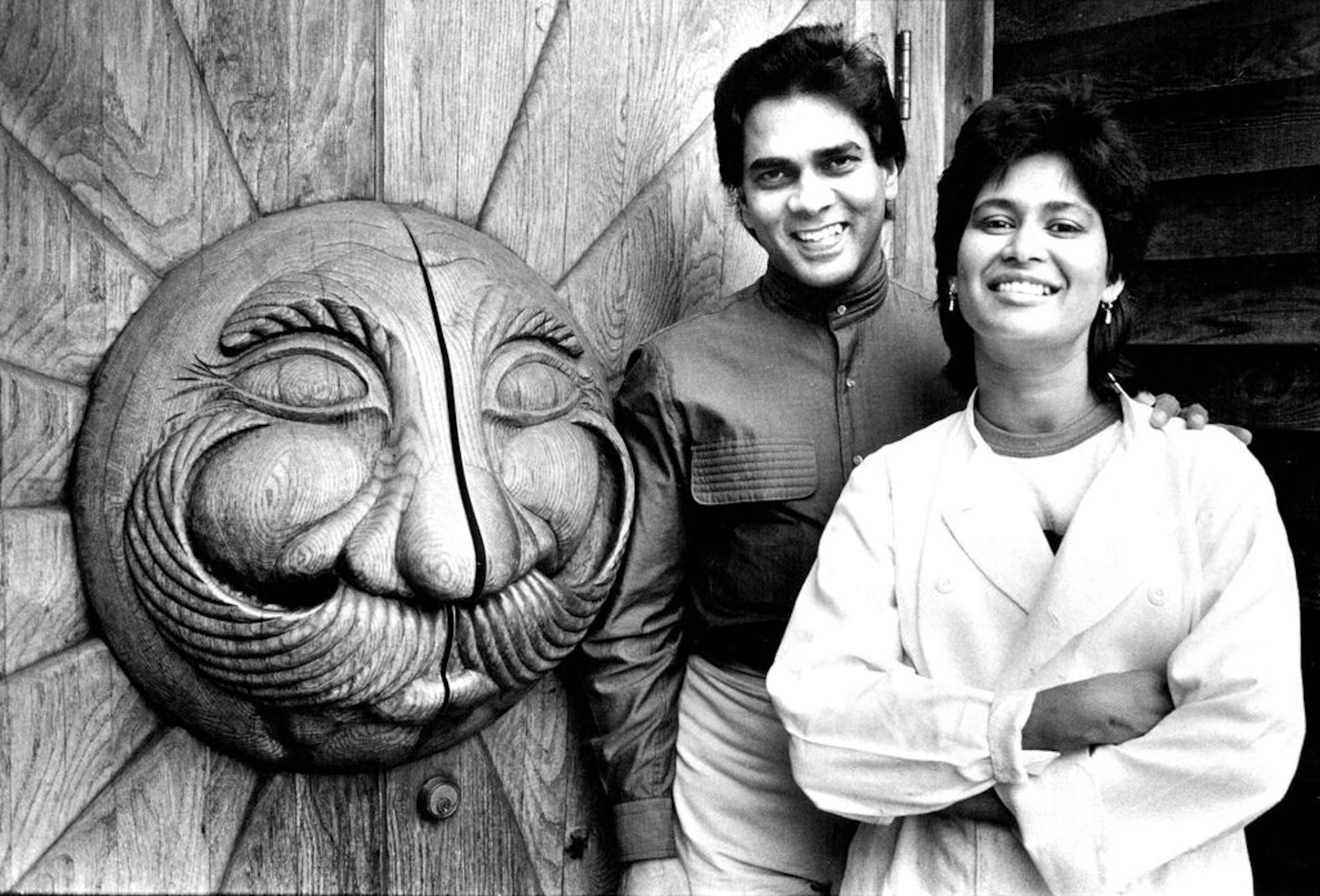 October 8, 1982 Evan and Heather Outside The Front Door of their Restaurant. Critic's choice/Dining out - The new quarters of the Sri Lanka Curry House in south Minneapolis (871-2400) offer more elbow room and the same spicy-hot food. Owners Evan (left) and Heather Balasuriya don't compromise on their fiery native chow: Pappadums, curried chicken, shrimp, beef or pork, curried crab claws, steamed, curried fish served with rice, dahl, chutneys and curried vegetables. Soothing guava or mango shake
