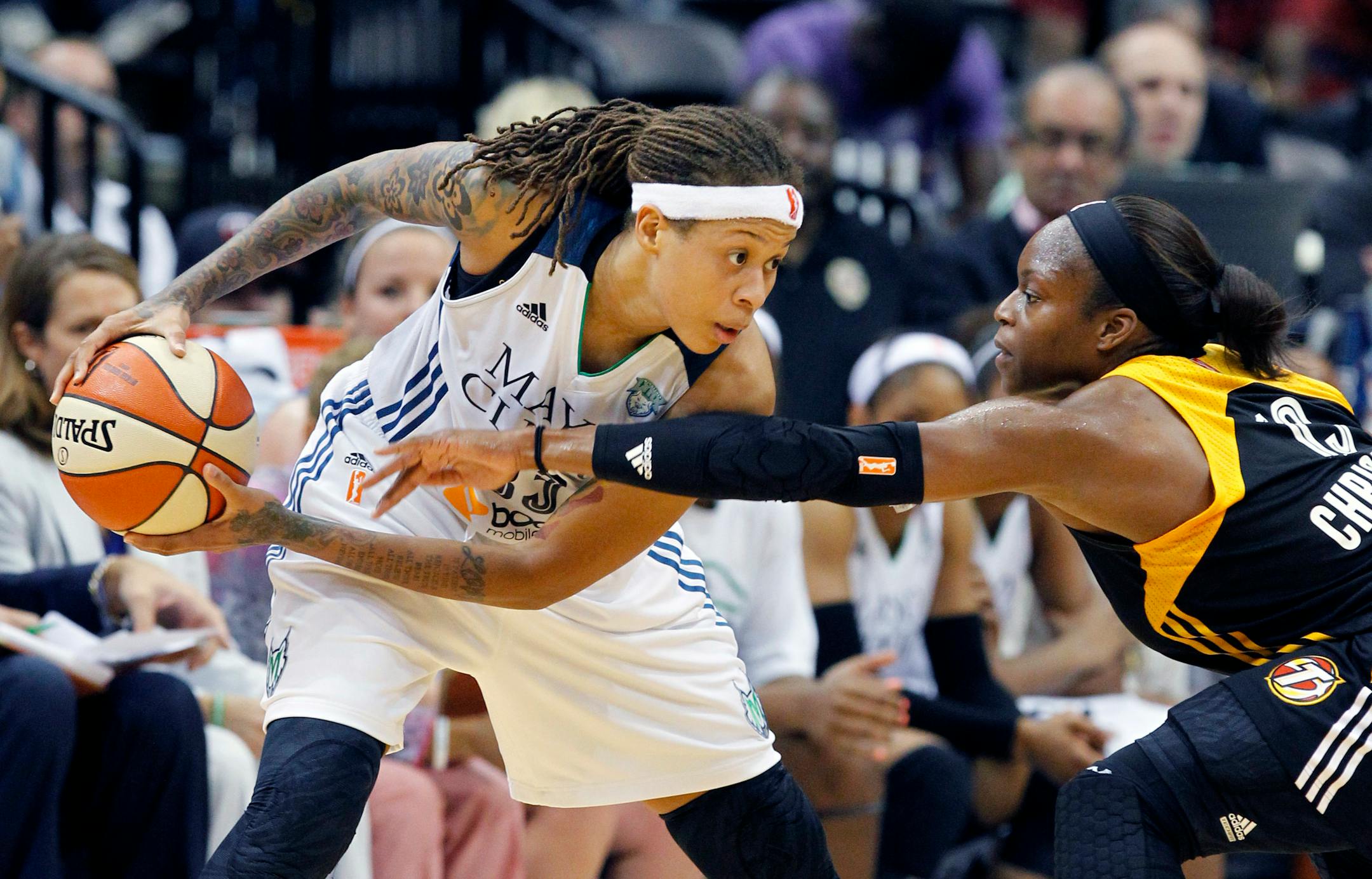 Minnesota Lynx guard Seimone Augustus, left, keeps the ball out of reach of Tulsa Shock guard Karima Christmas, right, during the second half of a WNBA basketball game in Minneapolis, Friday, June 5, 2015. The Lynx won 83-75. (AP Photo/Ann Heisenfelt)