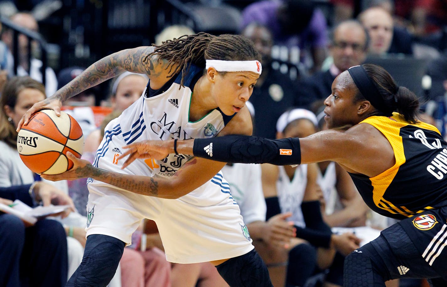 Minnesota Lynx guard Seimone Augustus, left, keeps the ball out of reach of Tulsa Shock guard Karima Christmas, right, during the second half of a WNBA basketball game in Minneapolis, Friday, June 5, 2015. The Lynx won 83-75. (AP Photo/Ann Heisenfelt)