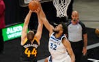 Minnesota Timberwolves center Karl-Anthony Towns (32) blocks the shot of Utah Jazz forward Bojan Bogdanovic (44) during the first half of an NBA baske