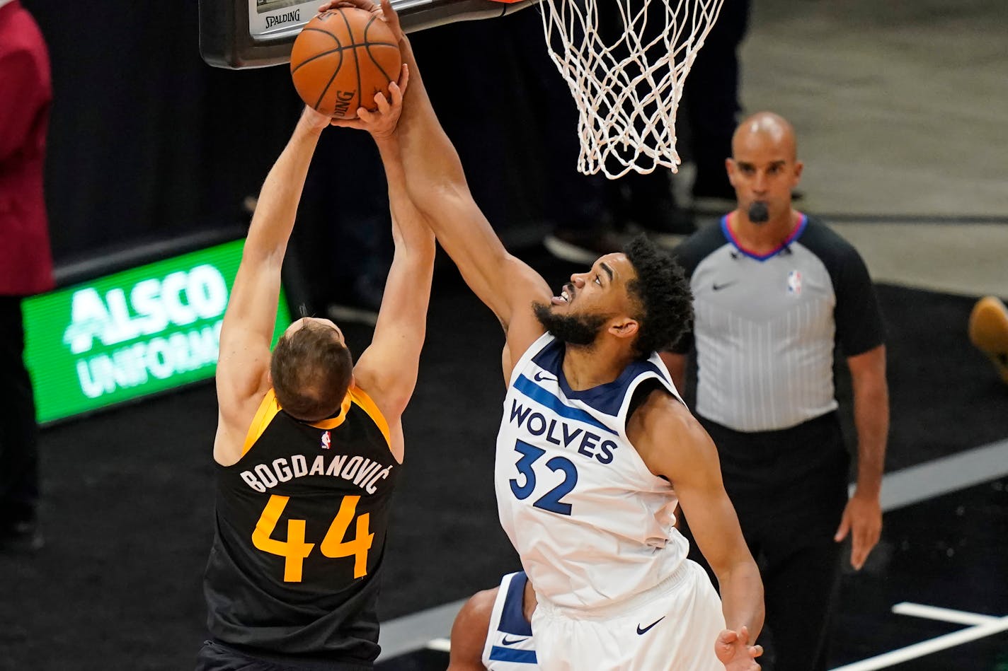 Minnesota Timberwolves center Karl-Anthony Towns (32) blocks the shot of Utah Jazz forward Bojan Bogdanovic (44) during the first half of an NBA basketball game Saturday, Dec. 26, 2020, in Salt Lake City. (AP Photo/Rick Bowmer)