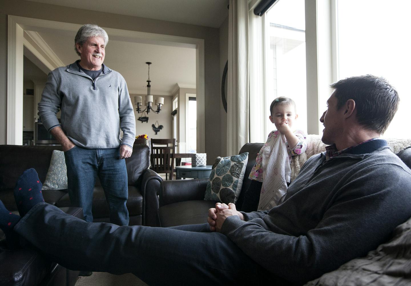 Minnesota Wild's Ryan Carter, right, and his dad, Mike Carter, watch Ryan's daughter Natalie, 15 months, at Ryan's home in Gem Lake November 22, 2015. (Courtney Perry/Special to the Star Tribune)