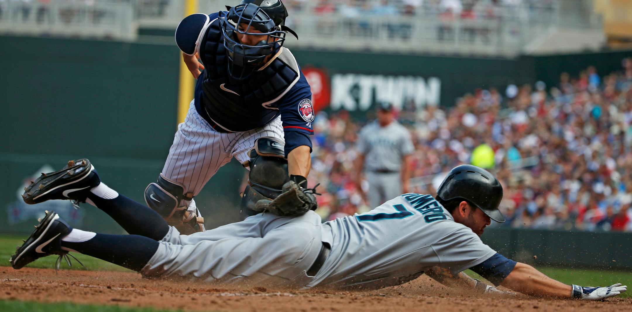 Seattle's Stefen Romero scored ahead of the tag by Twins catcher Kurt Suzuki in the seventh inning Sunday.
