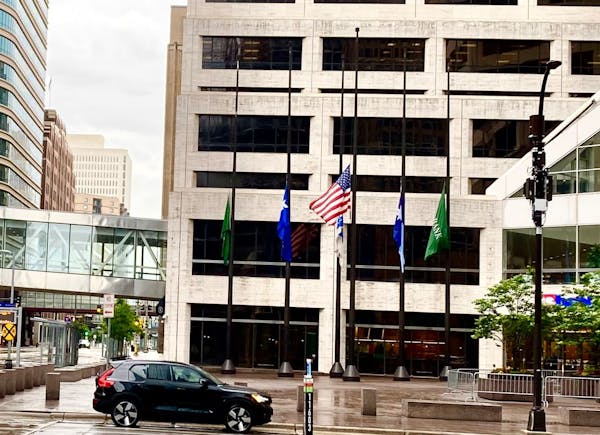 Flags at half-staff Friday in downtown Minneapolis.
