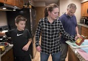 Tina Kill Lenling, son Isaac, 10, and husband Steve Lenling prepared dinner at their St. Paul home. Kill Lenling said the tools she's acquired from th