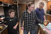 Tina Kill Lenling, son Isaac, 10, and husband Steve Lenling prepared dinner at their St. Paul home. Kill Lenling said the tools she's acquired from th