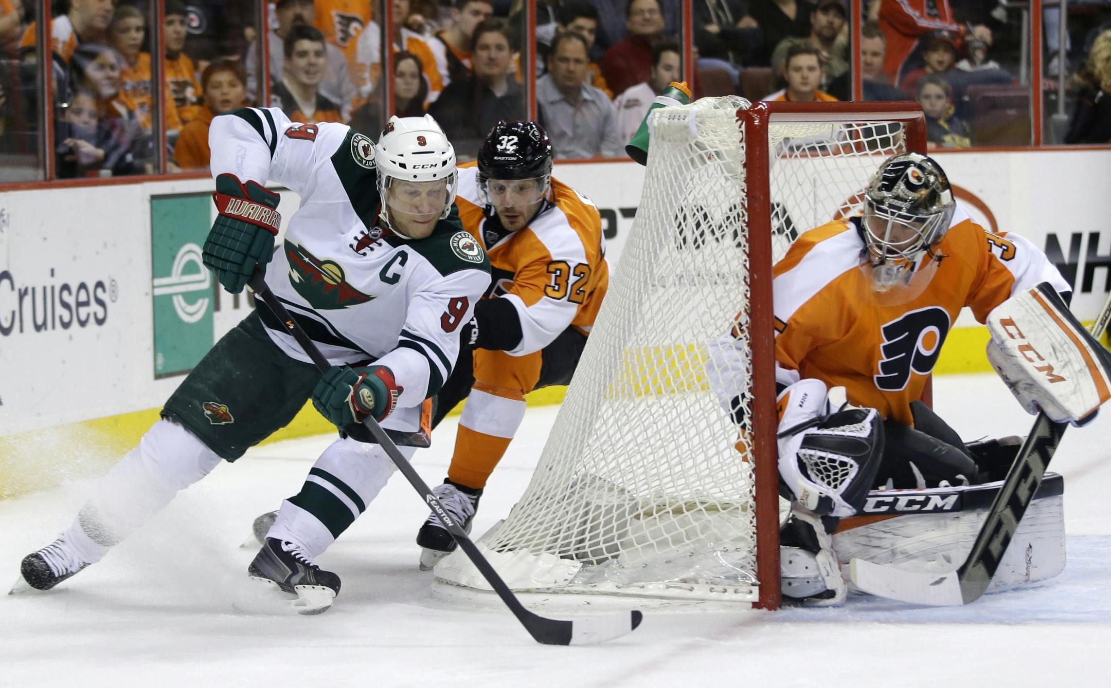 Minnesota Wild's Mikko Koivu (9), of Finland, tries to get a goal past Philadelphia Flyers' Mark Streit (32), of Switzerland, and Flyers' Steve Mason (35) during the first period of an NHL hockey game, Monday, Dec. 23, 2013, in Philadelphia.