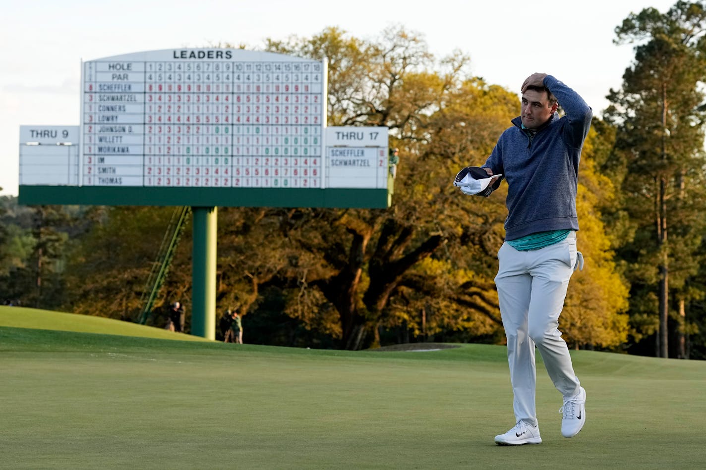 Scottie Scheffler walks off the 18th green after his third round at the Masters golf tournament on Saturday, April 9, 2022, in Augusta, Ga. (AP Photo/David J. Phillip)