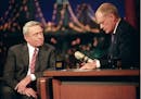 Dan Rather, anchor and managing editor of the CBS Evening News, is comforted by Late Show host David Letterman during a break after Rather was overcom