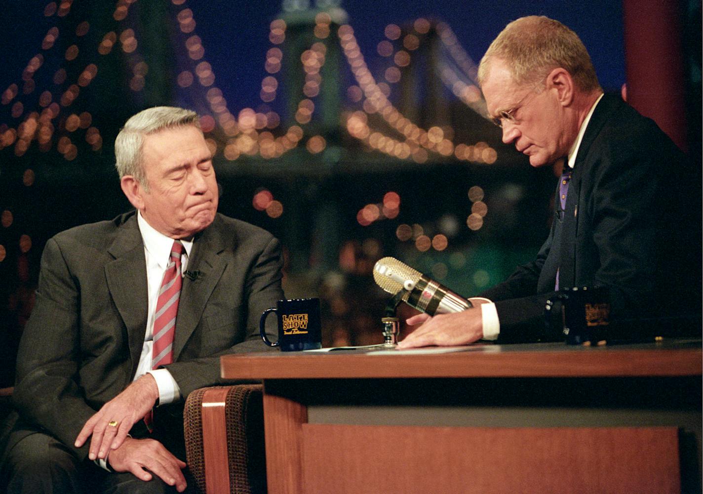 Dan Rather, anchor and managing editor of the CBS Evening News, is comforted by Late Show host David Letterman during a break after Rather was overcome by emotion while discussing the World Trade Center and Pentagon tragedies on The Late Show with David Letterman, September 17, 2001 on the CBS Television Network. This was the first broadcast of The Late Show with David Letterman following the tragedies of September 11, 2001. This photo is provided by CBS from the Late Show with David Letterman p