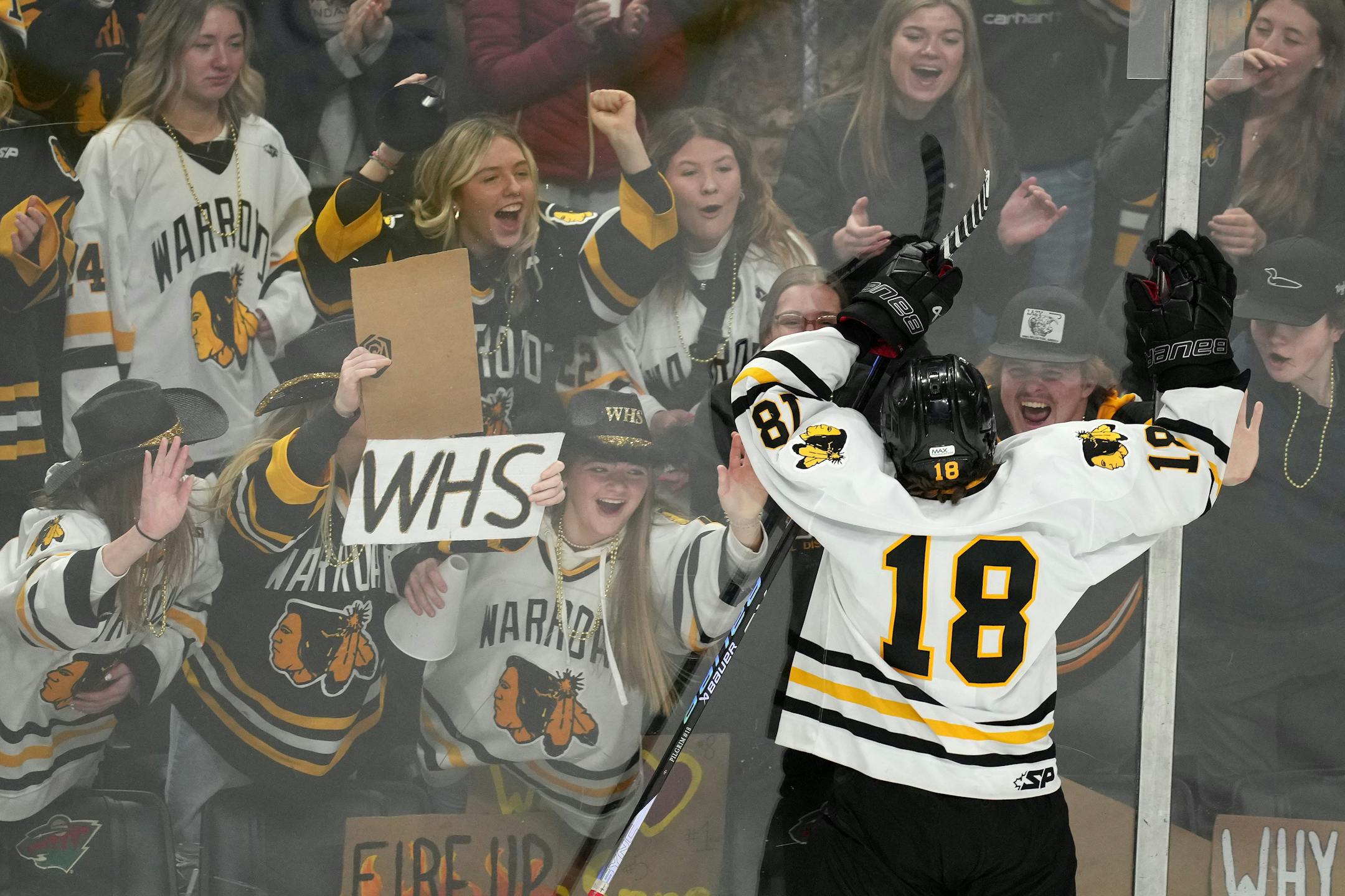 Warroad forward Carson Pilgrim (18) celebrates with the student section after scoring past Orono goaltender Brock Peyton (1) in the first period.