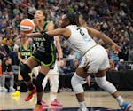 Lynx forward Napheesa Collier (24) is fouled by Liberty forward Kennedy Burke during the Lynx's 84-67 victory Saturday at Target Center.
