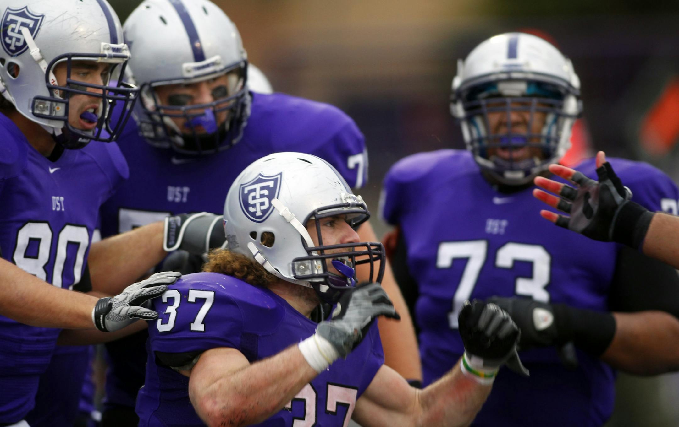 St. Thomas running back Colin Tobin (#37) celebrated with his teammates after scoring a second half touchdown.