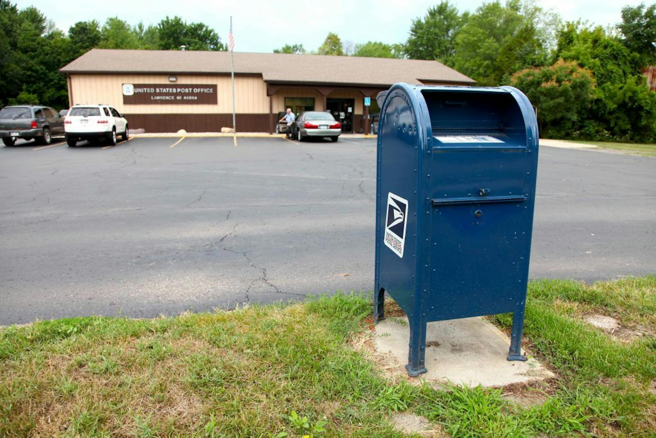 This photo taken July 27, 2012 shows a mailbox outside a US Post Office in Lawrence, Mich. The U.S. Postal Service is bracing for a first-ever default on billions in payments due to the Treasury, adding to widening uncertainty about the mail agency's solvency as first-class letters plummet and Congress deadlocks on ways to stem the red ink.