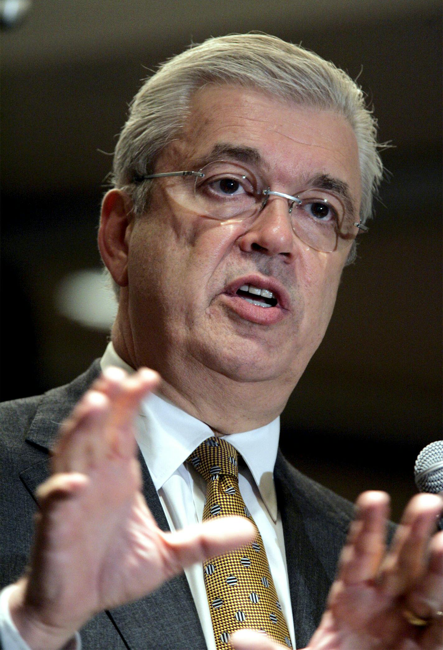 In this May 1, 2006 File Photo, William McGuire, then-CEO of health insurer United HealthGroup Inc., speaks to an audience of journalists at the Society of American Business Editors and Writers 43rd Annual Conference in Minneapolis, Minn. McGuire later left the company after questions were raised about stock options backdating. UnitedHealth on Wednesday said it will pay $895 million to settle lawsuits over its stock option practices, and it warned that weaker business and higher costs will cut i