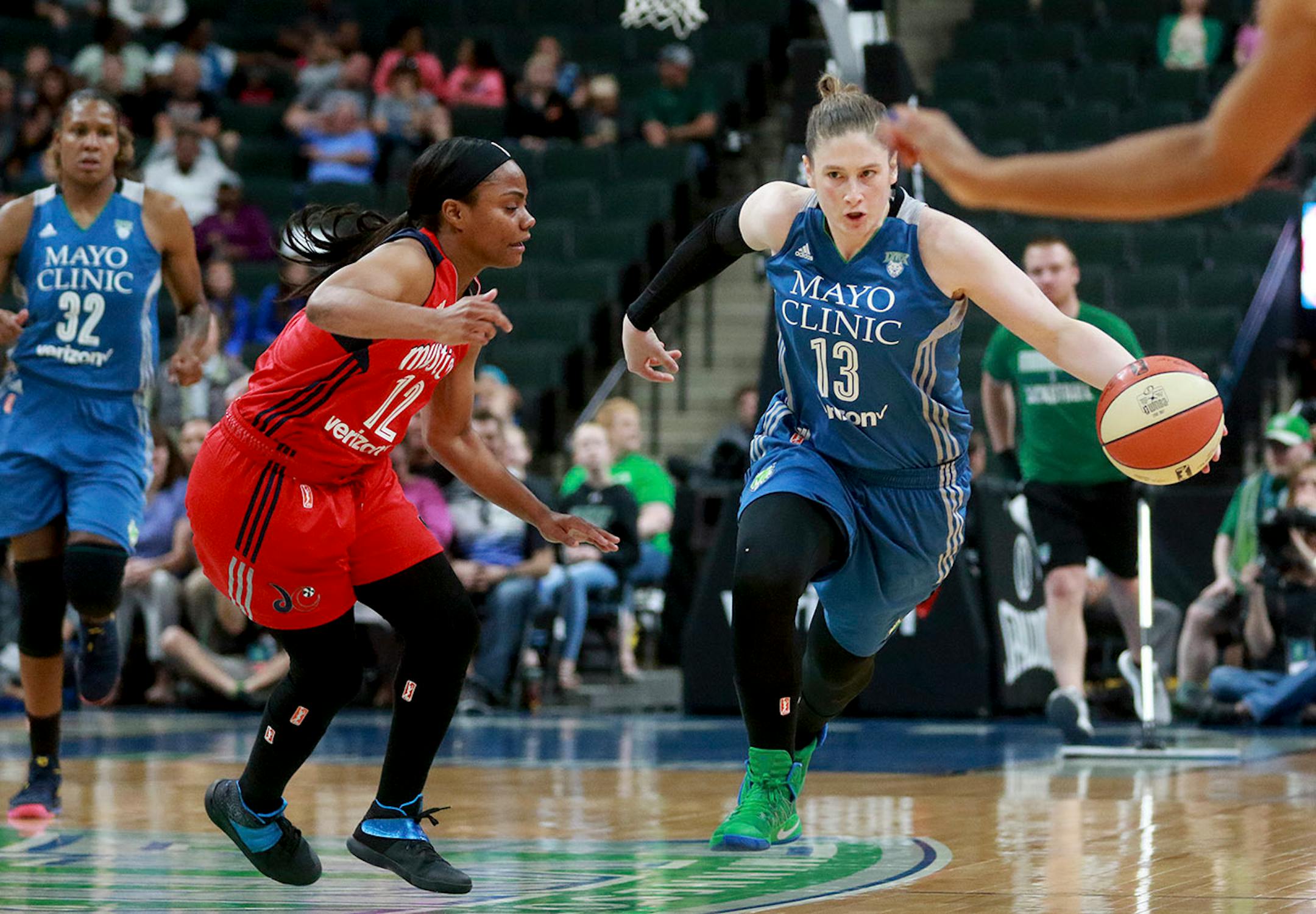 The Minnesota Lynx Lindsay Whalen (13) brings the ball up court past the Washington Mystic's Ivory Latta (12) during the second quarter Friday, June 22, 2017, at the Xcel Energy Center in St. Paul, MN.