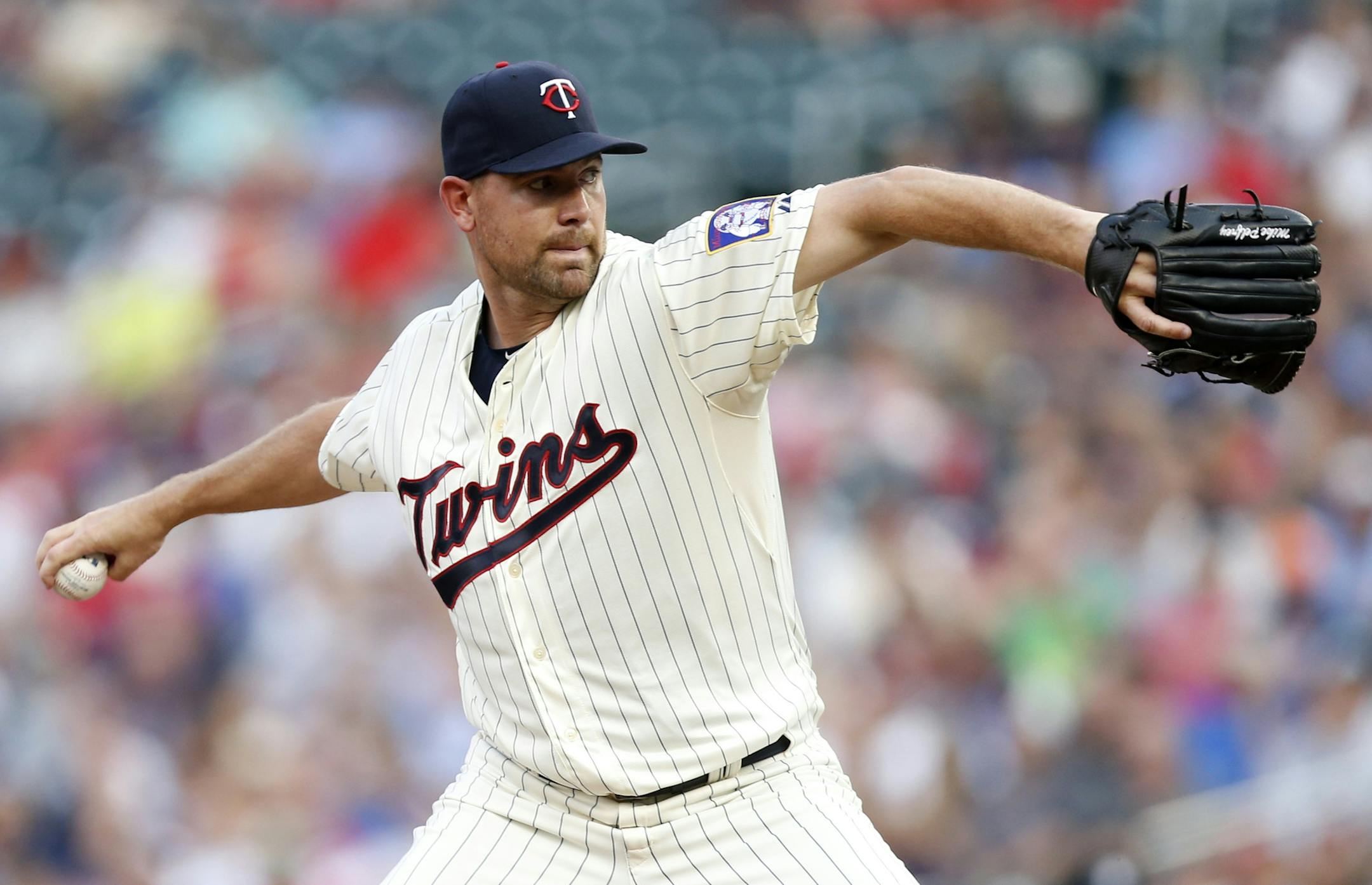 Minnesota Twins pitcher Mike Pelfrey throws against the Texas Rangers in the first inning of a baseball game, Wednesday, Aug. 12, 2015, in Minneapolis. (AP Photo/Jim Mone)