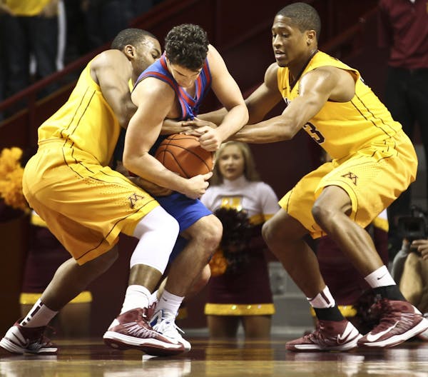 Gophers Andre Hollins and Rodney Williams Jr. trapped American University's Daniel Munoz on Friday night.