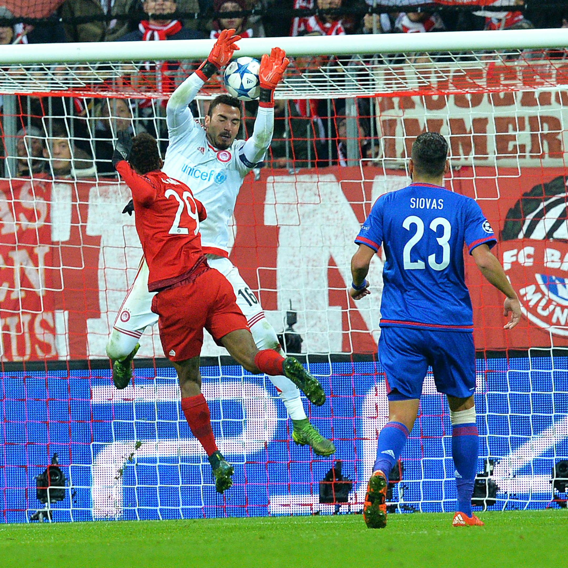 Bayern's Kingsley Coman, left, scores during the Champions League group F soccer match between FC Bayern Munich and Olympiakos in Munich, Germany, Tuesday, Nov. 24, 2015. (AP Photo/Kerstin Joensson)