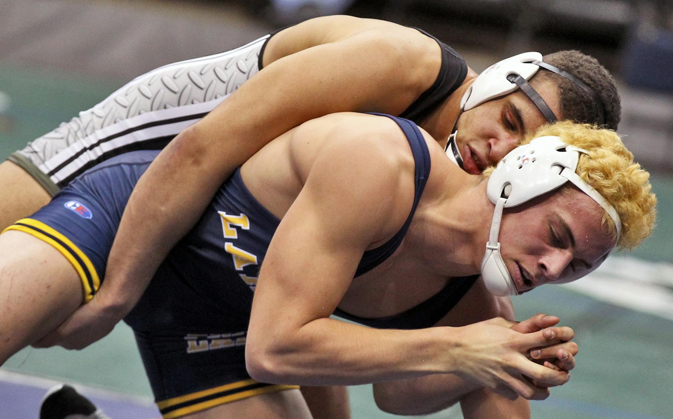 Roseville's Trae Story, top, and Alex Hart of Prior Lake wrestled in a 195-lb. match at the state tournament.
