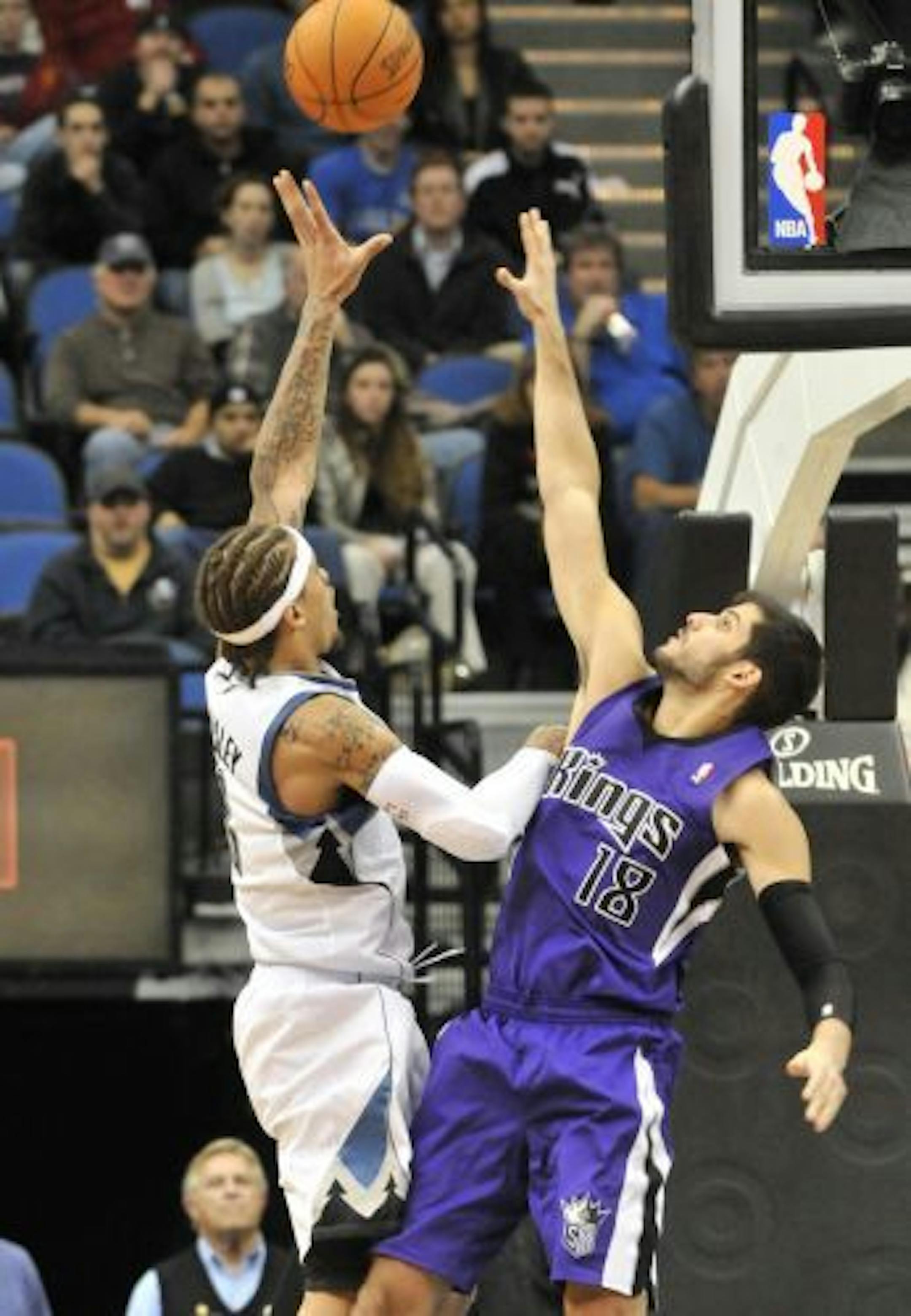 Minnesota Timberwolves' Michael Beasley, left, shoots over Sacramento Kings' Omri Casspi, of Israel, in the second half of an NBA basketball game Wednesday, Oct. 27, 2010, in Minneapolis. The Kings won 117-116. Beasley scored 17 points for the Timberwolves.