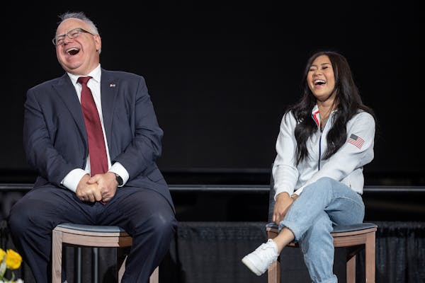 U.S. Olympic gold medalist Sunisa Lee, alongside Governor Tim Walz share a laugh, during an event in which it was announced that the 2024 U.S. Olympic