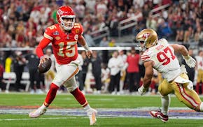 Kansas City quarterback Patrick Mahomes (15) eluded San Francisco defensive end Nick Bosa (97) during the second half of the Super Bowl on Sunday in L