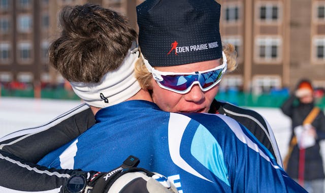 Eden Prairie nordic skier Benon Brattebo (202) embracs Blaine nordic skier Ben Lewis (204) after narrowly beating him to win the boy's freestyle pursu