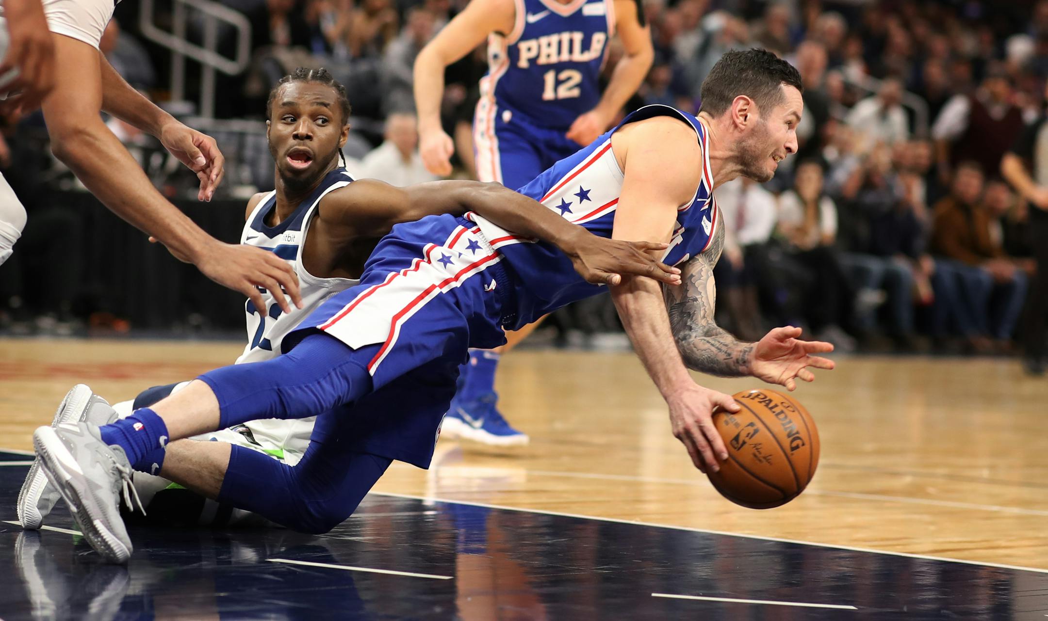 Minnesota Timberwolves forward Andrew Wiggins (22) fouled Philadelphia 76ers forward JJ Redick (17) during the second half of NBA action at Target Center Tuesday December 12, 2017 in Minneapolis, MN.] The Minnesota Timberwolves hosted the Philadelphia 76ers at Target Center. JERRY HOLT � jerry.holt@startribune.com