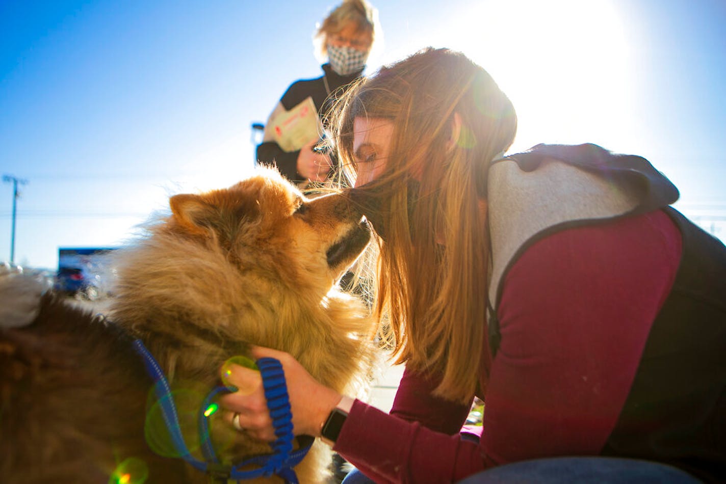 Melissa Buescher gives a kiss to her chow Leo after being reunited with him on Friday, Nov. 20, 2020, at Yellowstone Valley Animal Shelter in Billings, Mont. Buescher flew from Minneapolis to reunite with her dog after he got lost during an early October hike near Mystic Lake in the Beartooth Mountains.