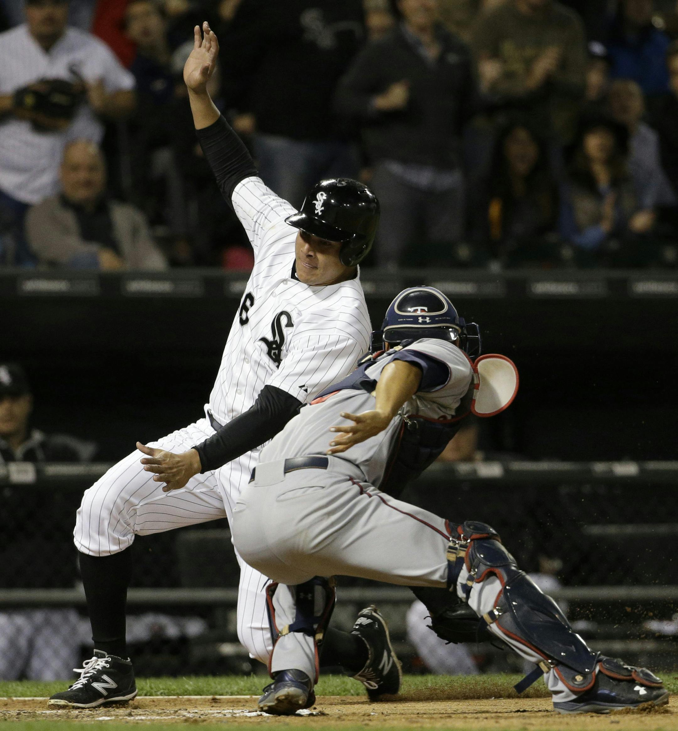 Minnesota Twins catcher Kurt Suzuki, right, tags out Chicago White Sox's Avisail Garcia during the fourth inning of a baseball game, Friday, Sept. 11, 2015, in Chicago. (AP Photo/Nam Y. Huh)