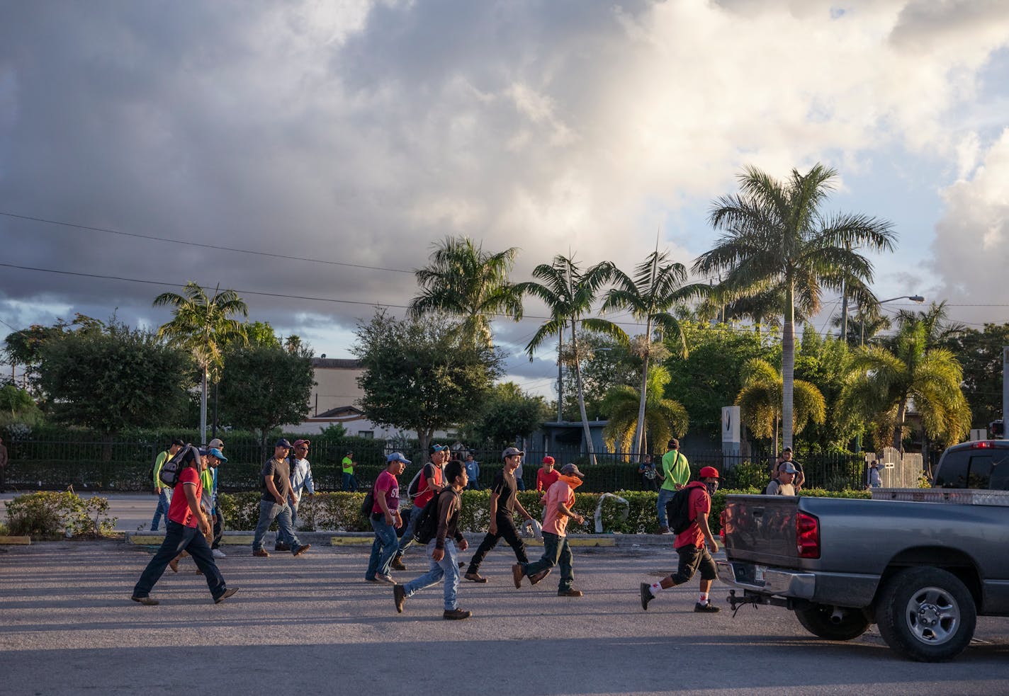 Day laborers, including some migrant children, gathered on a school day to find roofing, landscaping or other work, in Homestead, Fla. on Aug. 20, 2022. Alone and exploited, migrant children who are arriving to the U.S. in record numbers are ending up in dangerous jobs that violate child labor laws — including in factories that make some of the country's best-known products. (Kirsten Luce/The New York Times)