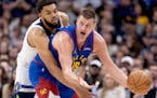 Karl Anthony Towns (32) of the Timberwolves defends Nikola Jokic (25) of the Nuggets during Game 1 of the Western Conference semifinals.