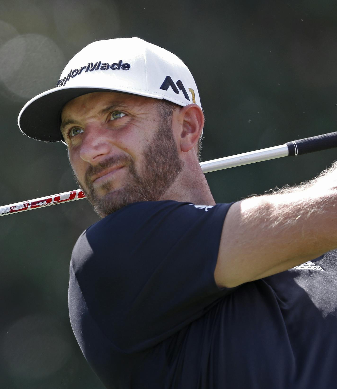 Dustin Johnson hits from the tee on the 14th hole during the third round of play at the Tour Championship golf tournament at East Lake Golf Club on Saturday, Sept. 24, 2016, in Atlanta. (AP Photo/John Bazemore) ORG XMIT: GAJB111