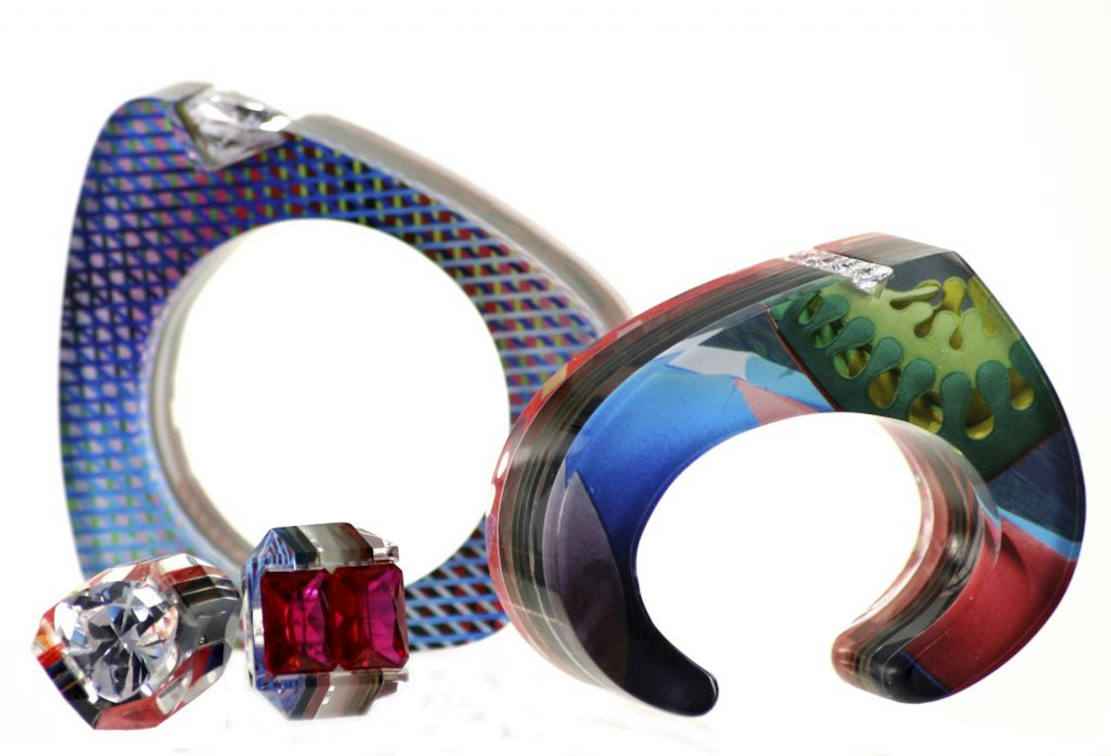 Jennifer Merchant laminates magazine images into chunky bracelets and rings.