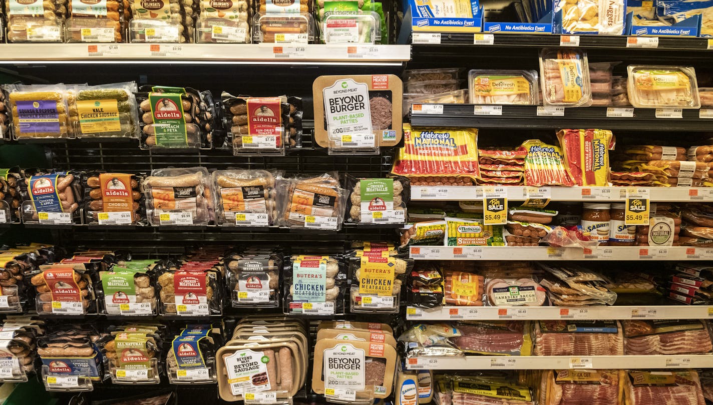 FILE -- Plant-based meat substitutes are displayed alongside meat products at a supermarket in New York on Aug. 30, 2019. Millennials are gobbling down plant-based burgers, prompting meat producers to question the health benefits of "ultra-processed imitations." (Evan Sung/The New York Times)