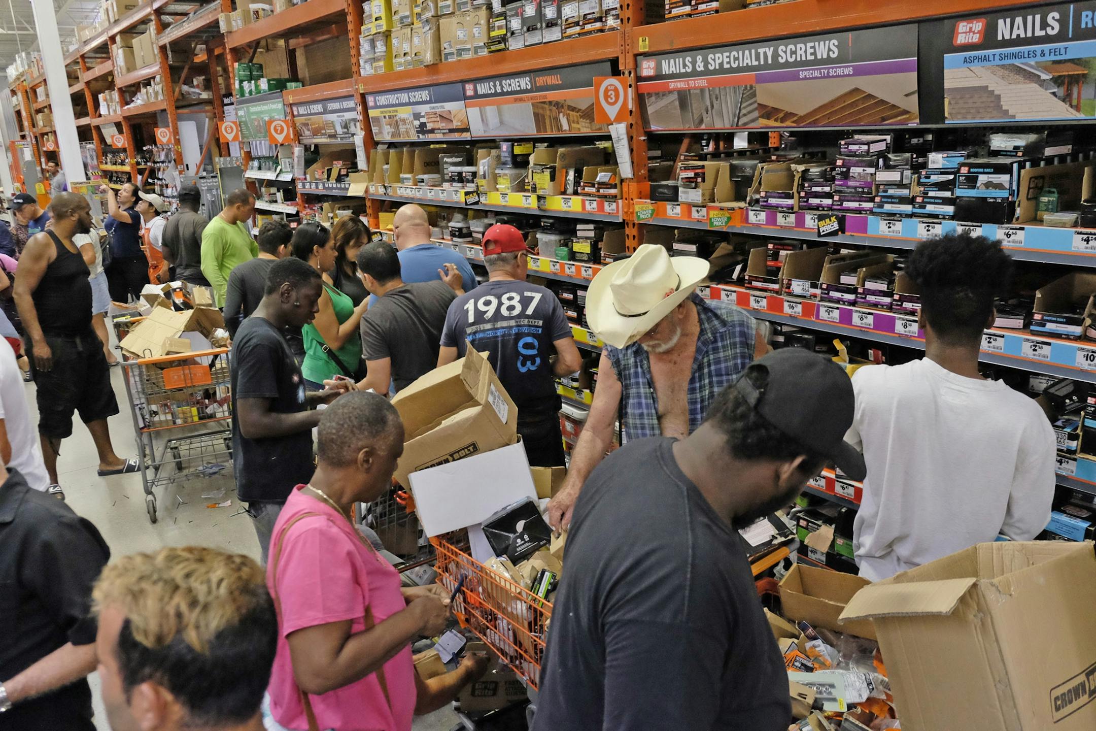 Customers at a Home Depot in South Miami Dade buy building materials to secure their property in anticipation of Hurricane Irma early Friday, Sept. 8, 2017 in Miami, Fla. The National Hurricane Center says Hurricane Irma weakened a bit more but remains a powerful threat to Florida.
