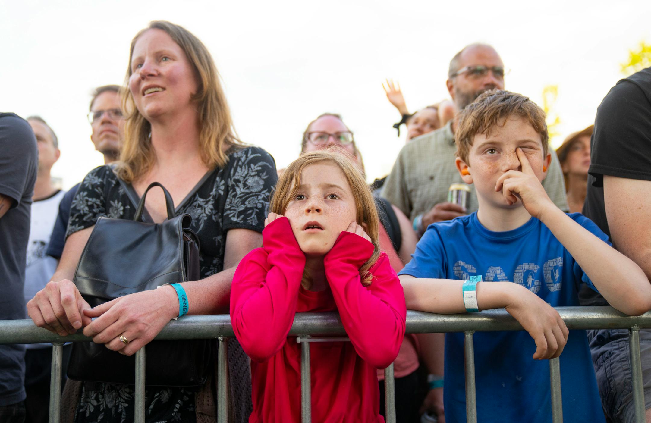 Melissa Stewart Ring, her daughter, Meta, 7, and Bernard, 9, left to right, watch as LOW performs during Rock the Garden.