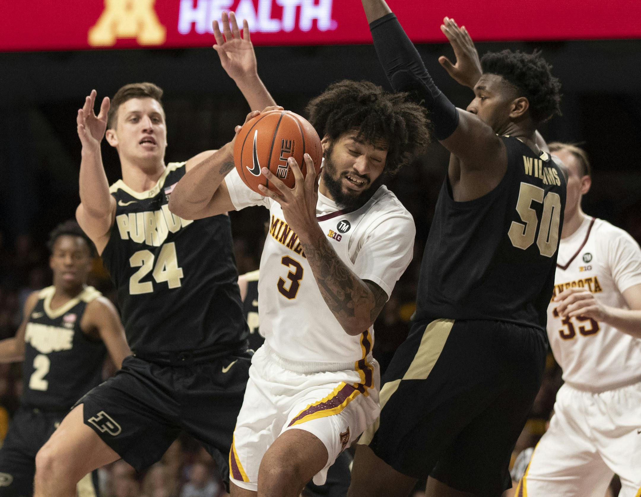 Minnesota Golden Gophers forward Jordan Murphy (3) split the defense of Purdue Boilermakers forward Grady Eifert (24) and forward Trevion Williams (50) in the first half of Big Ten action Tuesday March 5, 2019 at Williams Arena in Minneapolis, MN.] Minnesota hosted Purdue Jerry Holt • Jerry.holt@startribune.com