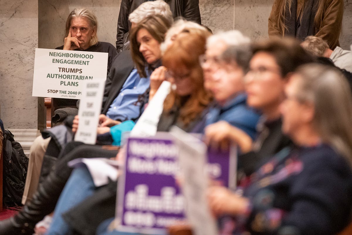 In 2018, a Planning Commission meeting attracted a crowd with signs for and against the 2040 Plan. 