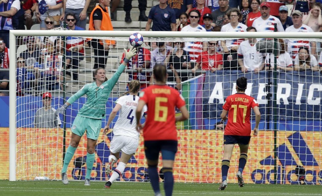 United States goalkeeper Alyssa Naeher, left, fails to stop a goal shot by Spain's Jennifer Hermoso during the first half. It tied the game at 1-1.