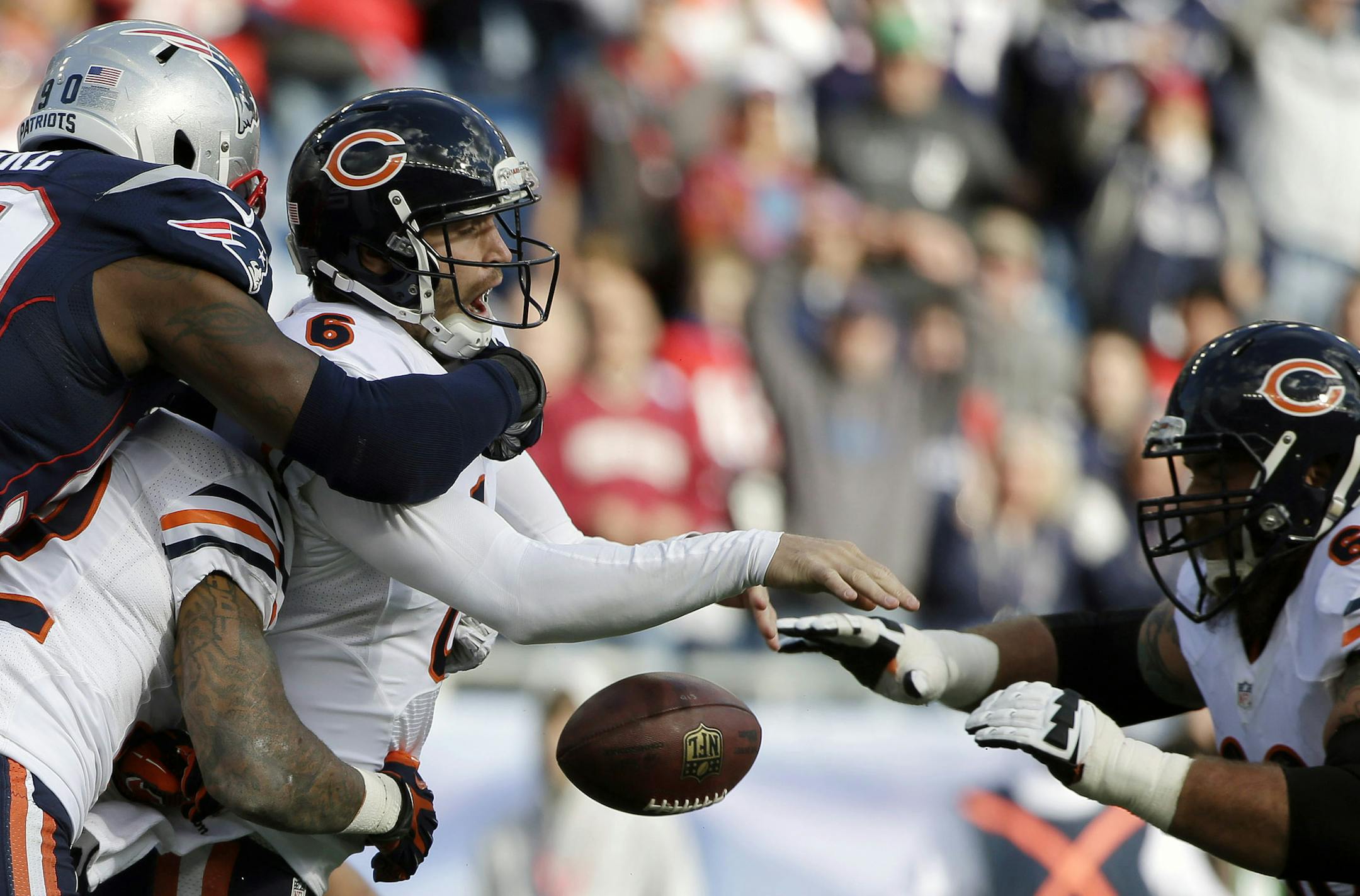 New England Patriots defensive end Zach Moore (90) forces Chicago Bears quarterback Jay Cutler (6) to fumble in the first half of an NFL football game on Sunday, Oct. 26, 2014, in Foxborough, Mass. (AP Photo/Steven Senne)