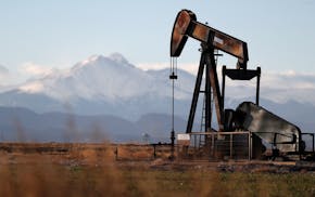 A pump jack over an oil well along Interstate 25 near Dacono, Colo.