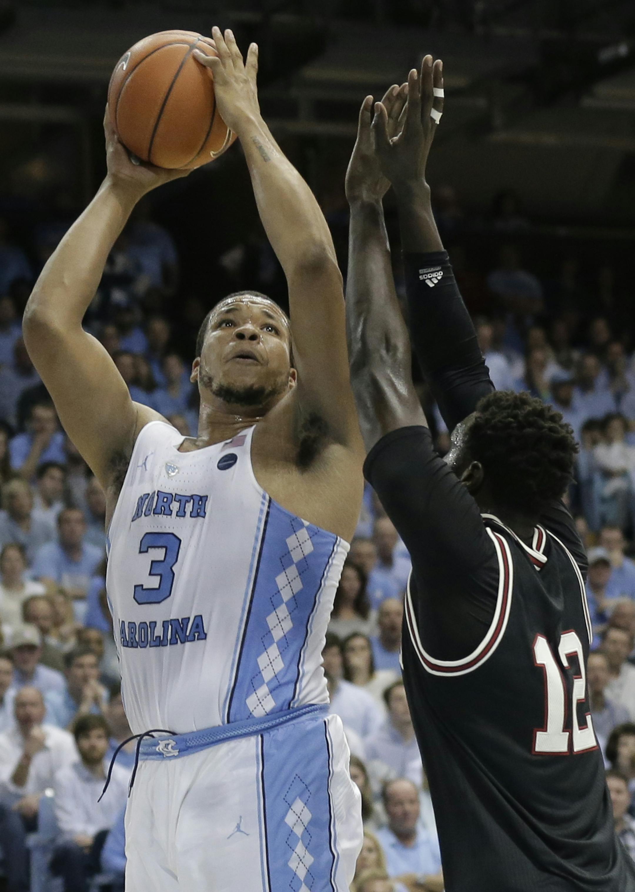 FILE- In this Feb. 22, 2017, file photo, North Carolina's Kennedy Meeks (3) shoots as Louisville's Mangok Mathiang (12) defends during the first half of an NCAA college basketball game in Chapel Hill, N.C. The 6-foot-10 senior is averaging 9.1 rebounds to help the Tar Heels lead the country in rebounding margin entering the Friday, March 24, game against Butler in the NCAA Tournament's South Region semifinals. (AP Photo/Gerry Broome, File)