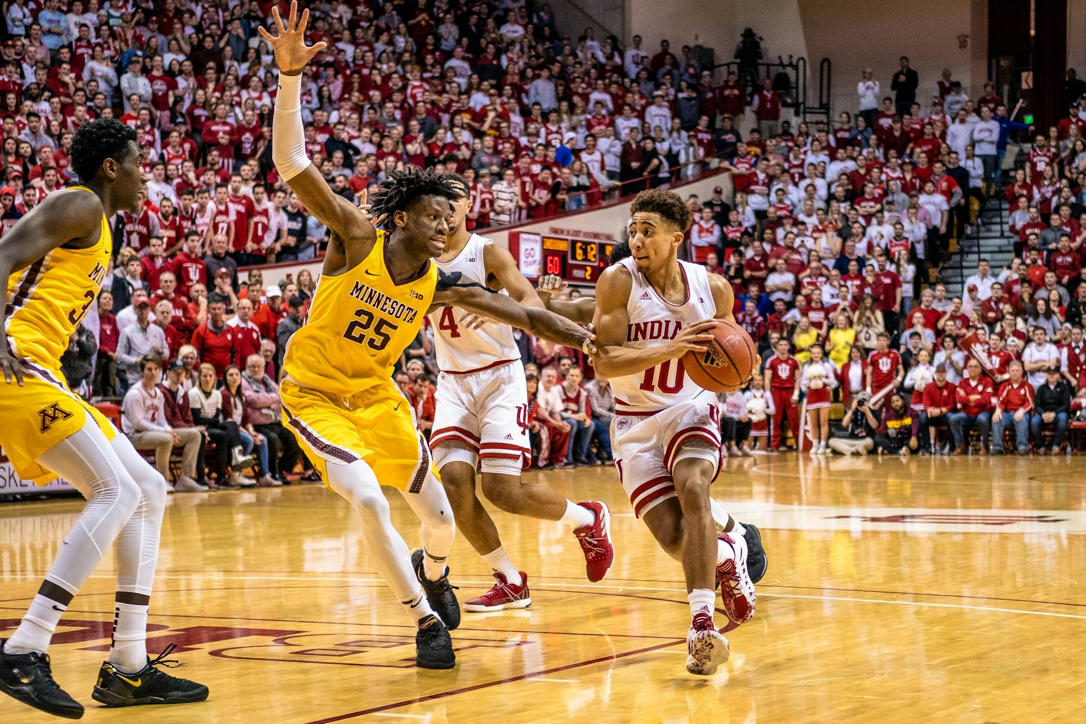 Indiana guard Rob Phinisee pushes through the Gophers' Daniel Oturu to make a lay-up on Wednesday at Assembly Hall.
