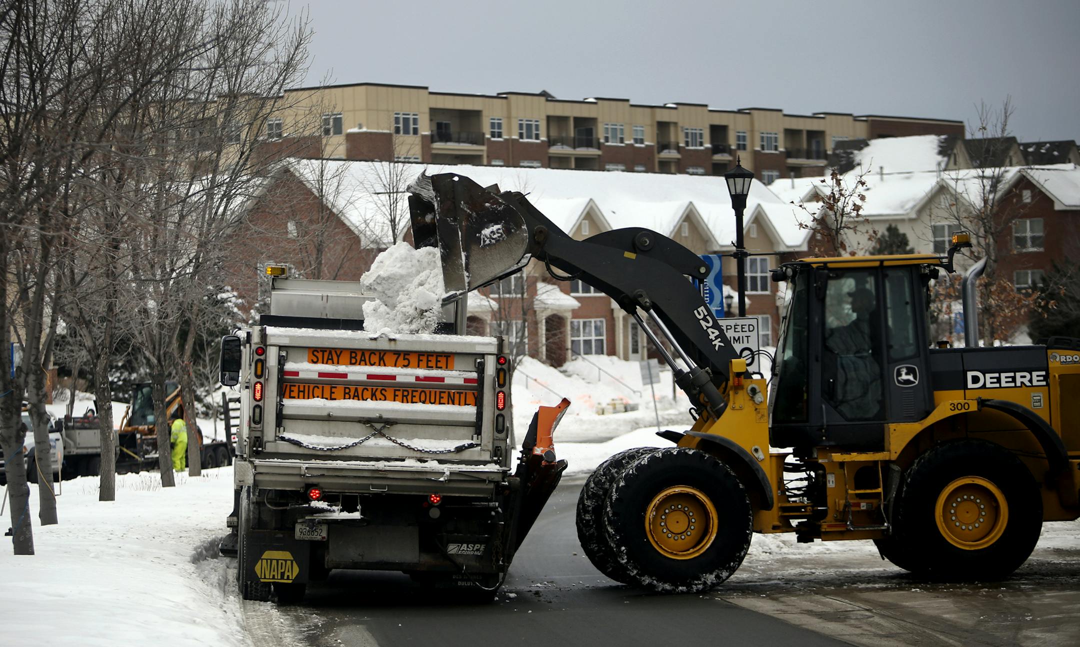 Burnsville snow removal crews remove some of this winter's snowfall in the Heart of the City neighborhood Thursday, March 6, 2014, in Burnsville, MN.](DAVID JOLES/STARTRIBUNE) djoles@startribune.com From snowplows and drivers working overtime to cities trying to figure out what to do with all the snow, municipalities like Burnsville have seen their snow removal budgets eaten up for the year.