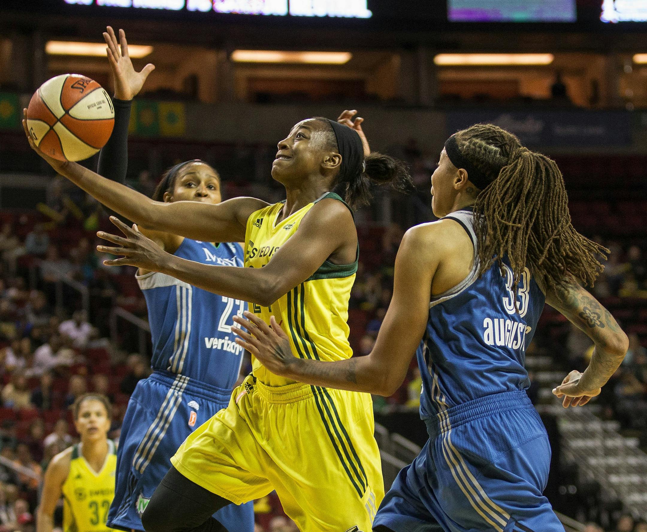 Seattle Storm's Jewell Loyd splits Minnesota Lynx defenders but cannot get the shot to drop in the first half of a WNBA basketball game Saturday, June 3, 2017, in Seattle. (Dean Rutz/The Seattle Times via AP)